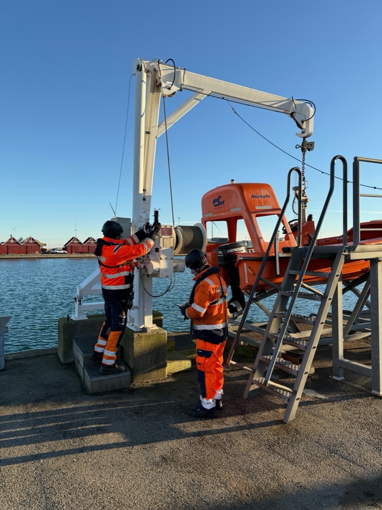 CRALOG inspectors testing a lifeboat davit at the harbour
